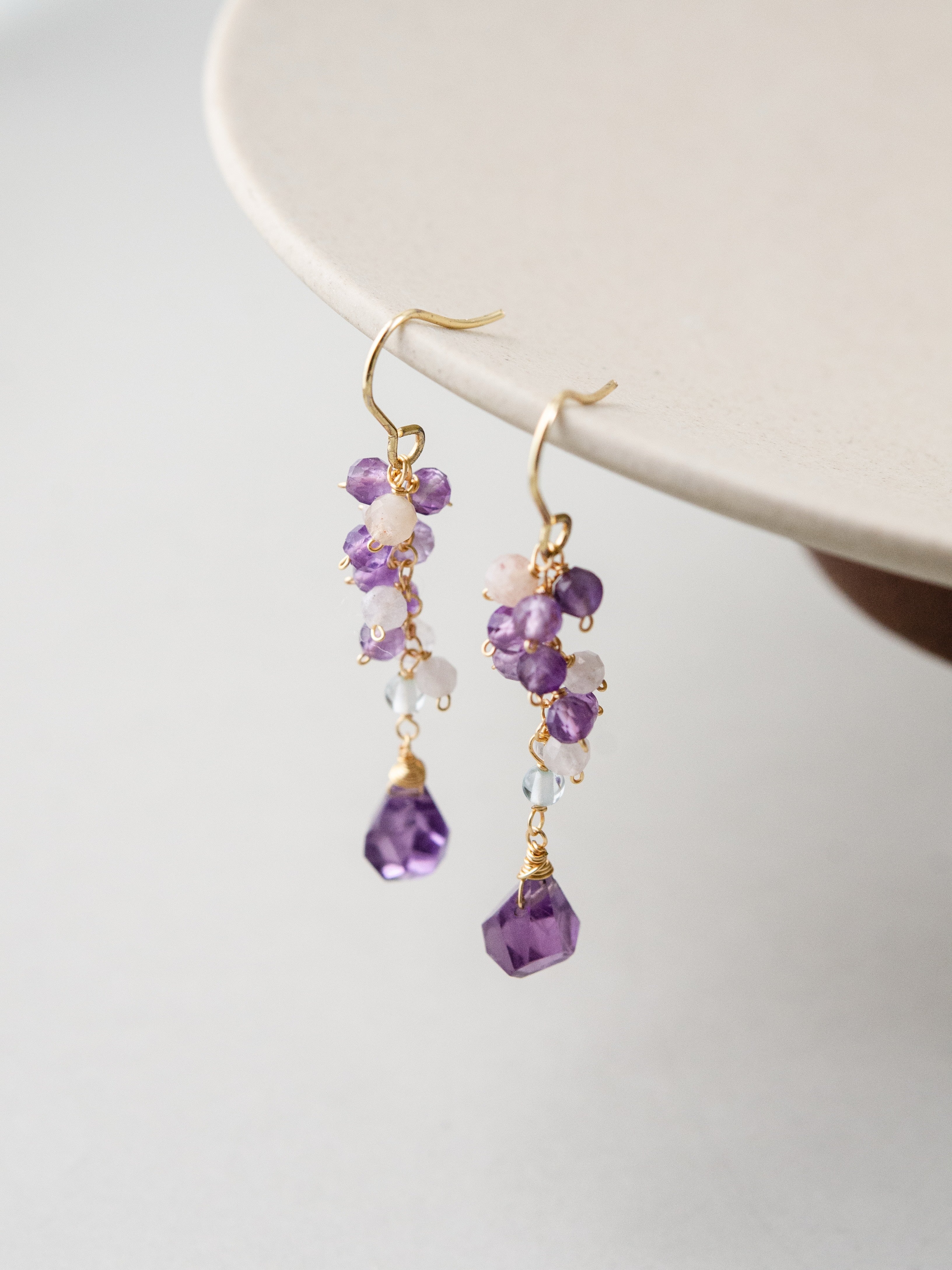 2月誕生石 アメジスト ピアス 白い皿の縁にディスプレイ 繊細なグラデーション