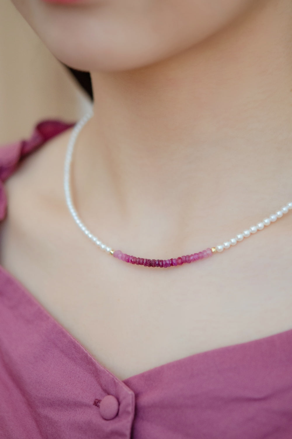 ネックレス着用 横顔 ピンクの服に映えるルビーの赤