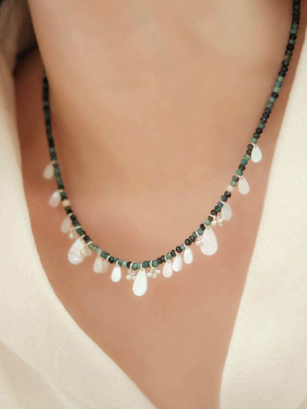 トルマリンネックレス着用 ベージュのVネックトップス スタイリング例